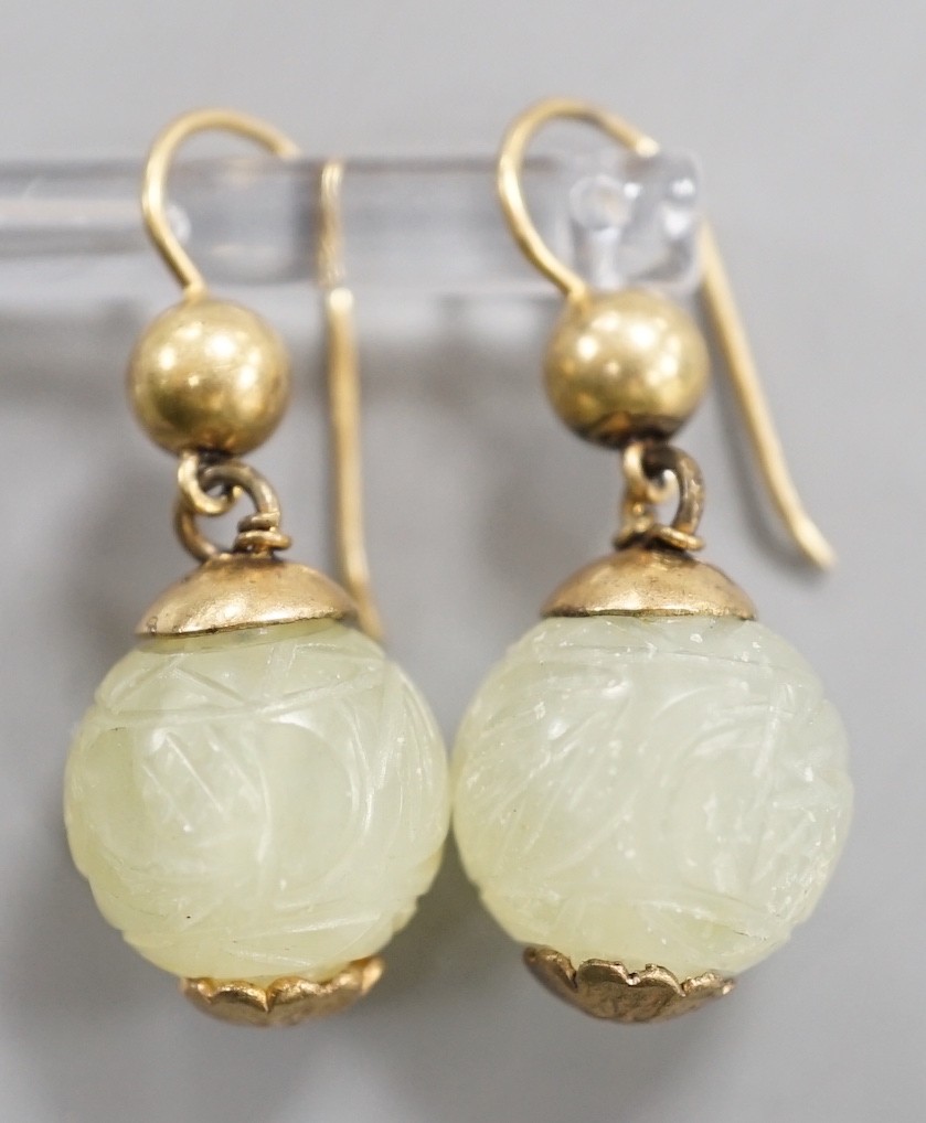 A pair of antique gilt metal and carved hardstone spherical drop earrings, jade diameter 14mm.